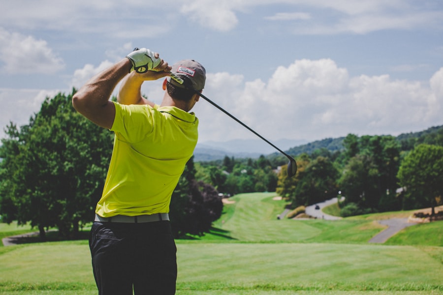 A golfer following through on a swing on a grassy driving range